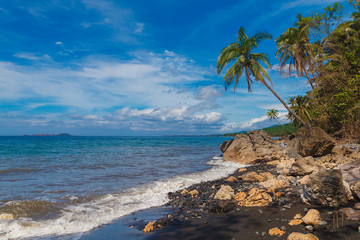 Beautiful tropical beach with black sand. Summer vacation concep