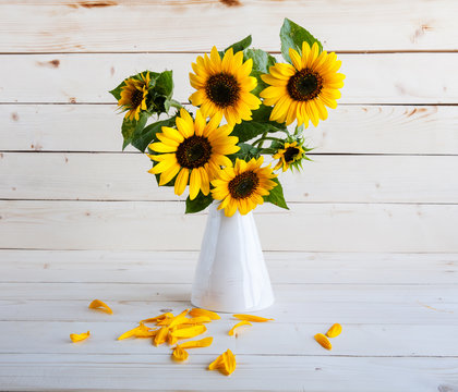Sunflowers in a vase on a rustic, gray background
