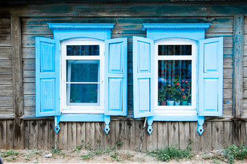 Two aged window of a old wooden house in Russia