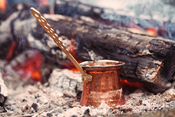 Making coffee in the fireplace  on camping or hiking in the natu