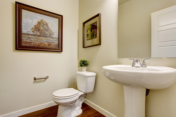 Bright bathroom with white washbasin stand and toilet