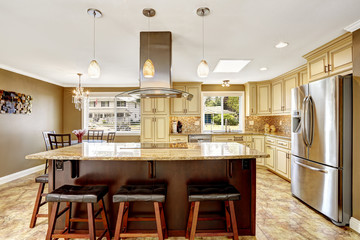 Beautiful kitchen island with granite top and hood