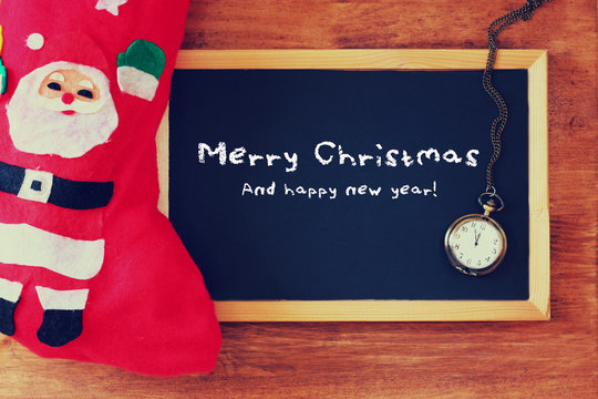 red sock and blackboard with merry christams greeting 