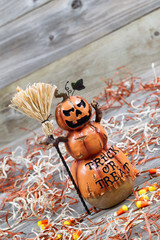 Scary large orange pumpkin ceramic figure on old wood