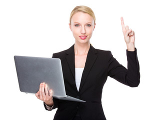 Caucasian businesswoman with laptop and finegr point up