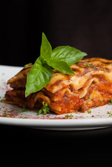 Lasagna on a square white plate