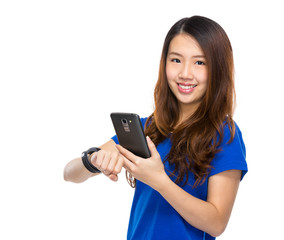 Fototapeta premium Woman use mobile phone synchronization to wearable watch