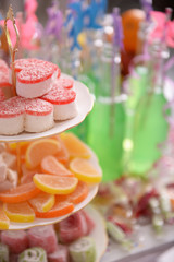 Sweets and bottles of drink with straw close up