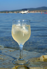 Glass of white wine by the coast