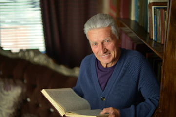 Handsome retired man reading book