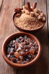 Brown sugar cubes, reed and crystal sugar in bowls