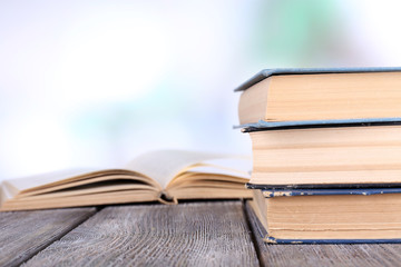 Books on wooden table on natural background