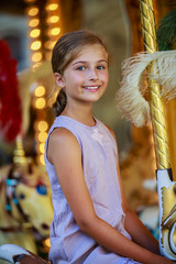 Merry-go-round - girl playing on carousel