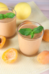 Apricot dessert in glasses on table close-up
