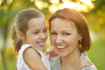 Little girl hugging her mother