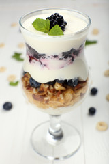 Natural yogurt with fresh berries on wooden table