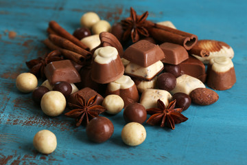 Different kinds of chocolates on wooden table close-up