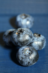Tasty ripe blueberries, on wooden background