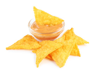 Tasty nachos and bowl with sauce isolated on white