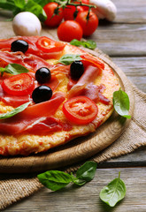 Delicious pizza served on wooden table
