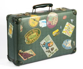 Poster Old vintage suitcase with travel labels © photology1971