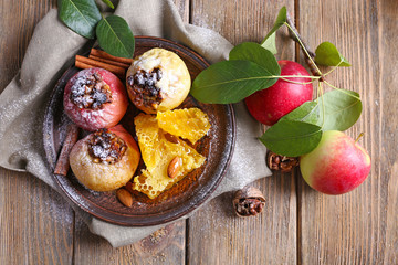 Baked apples on plate on table close up