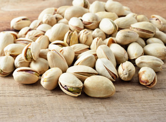 Pistachio nuts, close up on wooden table