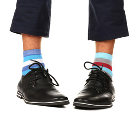 Man leg in suit and colorful socks, isolated on white