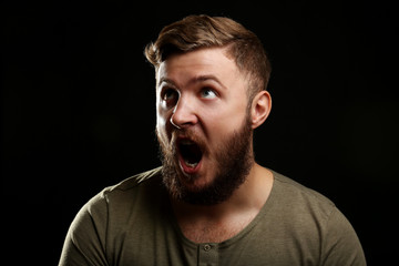 Portrait of handsome man with beard on black background