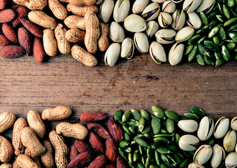 Nuts and dried fruits on vintage wooden boards still life
