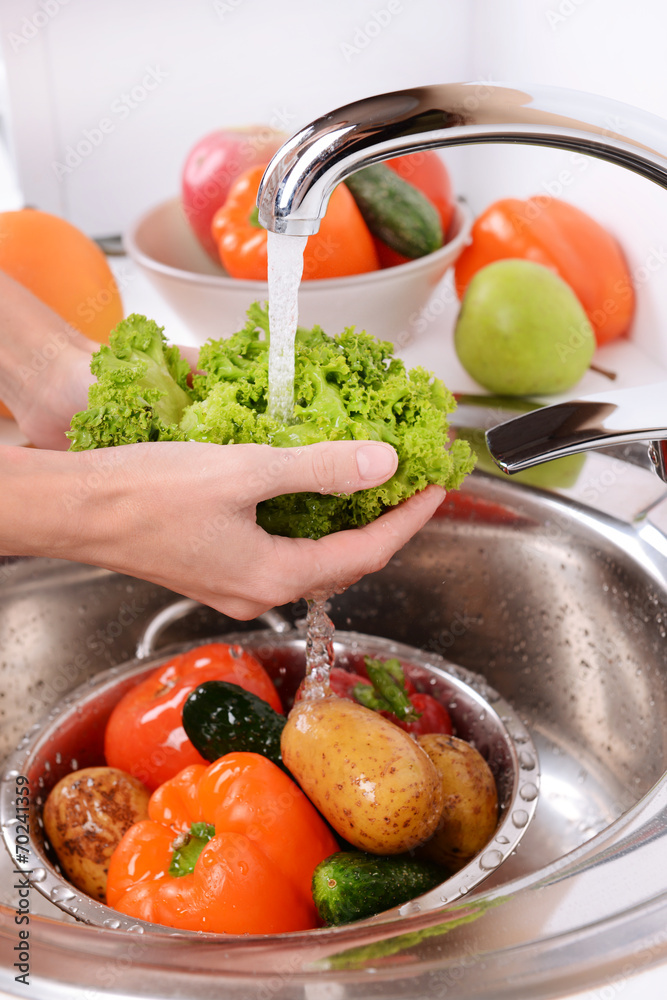 Wall mural Washing fruits and vegetables close-up