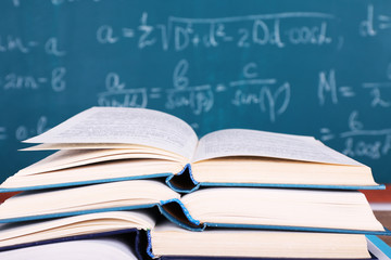 Books on blackboard background