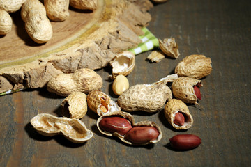 Peanuts in bowl on rustic wooden background