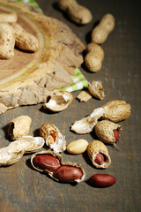 Peanuts in bowl on rustic wooden background