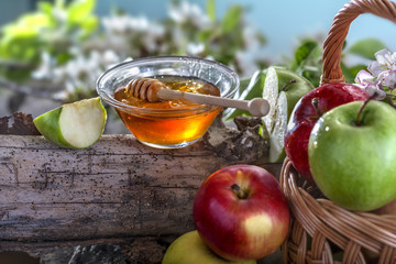 Domestic apples and honey on the natural rustic background