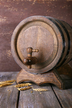 Barrel and ears on wooden table on wooden wall background