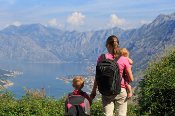 mother with kids looking at mountains on vacation