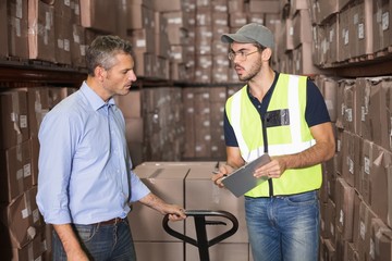 Warehouse manager talking with worker