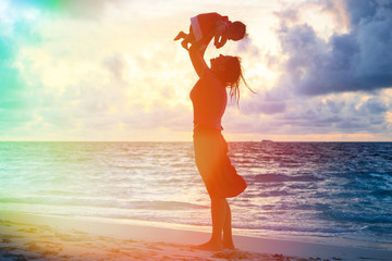 mother and daughter having fun at sunset beach © nadezhda1906