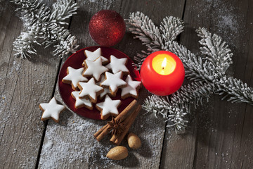 Zimtsterne mit Weihnachtsdekoration auf Holzuntergrund