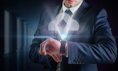 Composite image of businessman using hologram watch