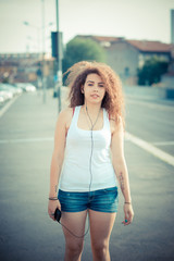 young beautiful long curly hair hipster woman listening music