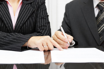 business woman  show a businessman  to sign a agreement - obrazy, fototapety, plakaty