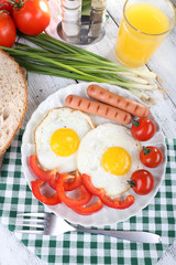 Scrambled eggs with sausage and vegetables served