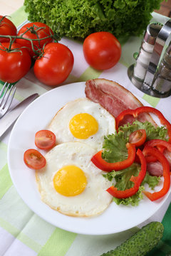 Scrambled eggs with bacon and vegetables served