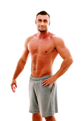 Fototapeta premium Happy muscular sportsman standing over white background