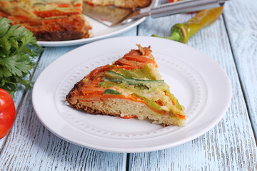 Piece of casserole with vegetables on plate on table close-up
