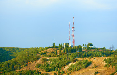 Fototapeta na wymiar Television tower on top of a hill.