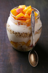 Healthy breakfast - yogurt with  fresh peach and muesli served