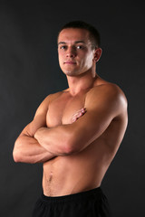 Fototapeta premium Handsome muscle young man on dark background